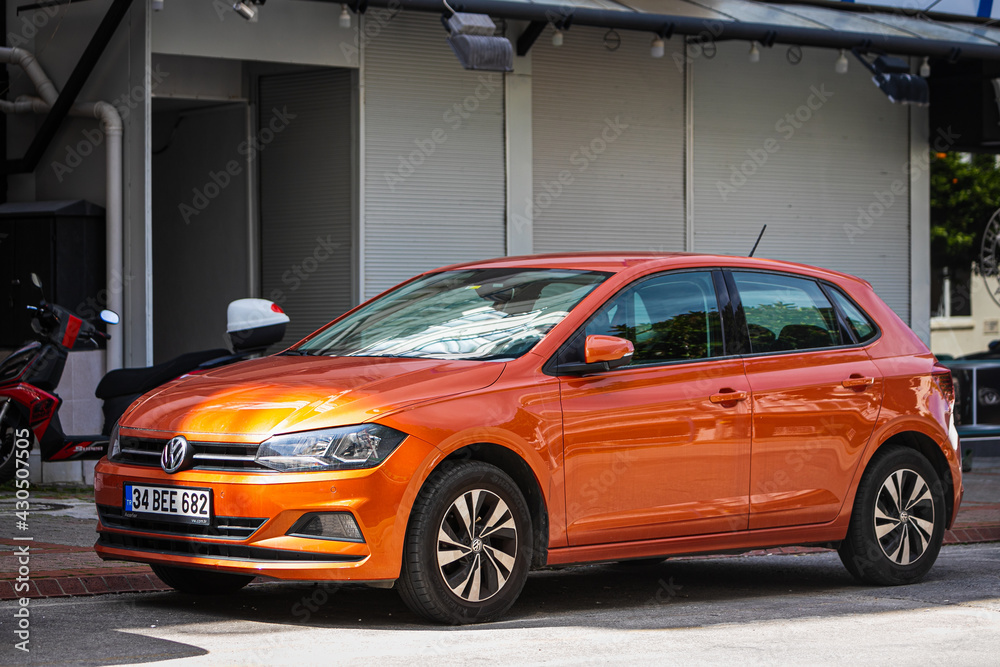 Alanya, Turkey – April 12 2021: orange Volkswagen Polo is parked on the  street on a warm summer day against the backdrop of a street, front side  Photos | Adobe Stock