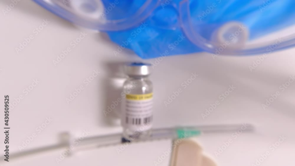 Slow motion over medical scientist table with Covid-19 or Coronavirus vaccines vials and syringes. Macro close up of the fixed focus floating over the lab in hospital. Slow motion over medical scientist table with Covid-19 or Coronavirus vaccines vials and syringes. Macro close up of the fixed focus floating over the lab in hospital.