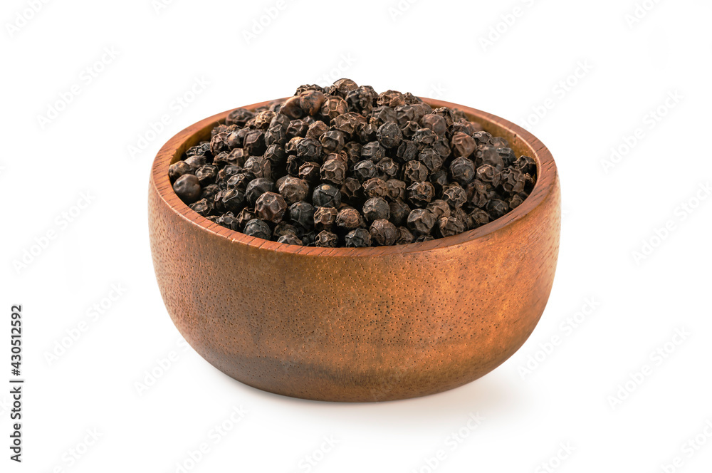 Black pepper in a wooden bowl isolated on white background. Black pepper in a wooden bowl isolated on white background.