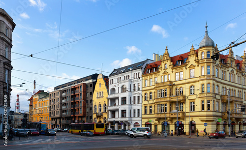 Wroclaw modern cityscape with wide streets and traditional historical tenement houses in sunny spring day, Poland. High quality photo