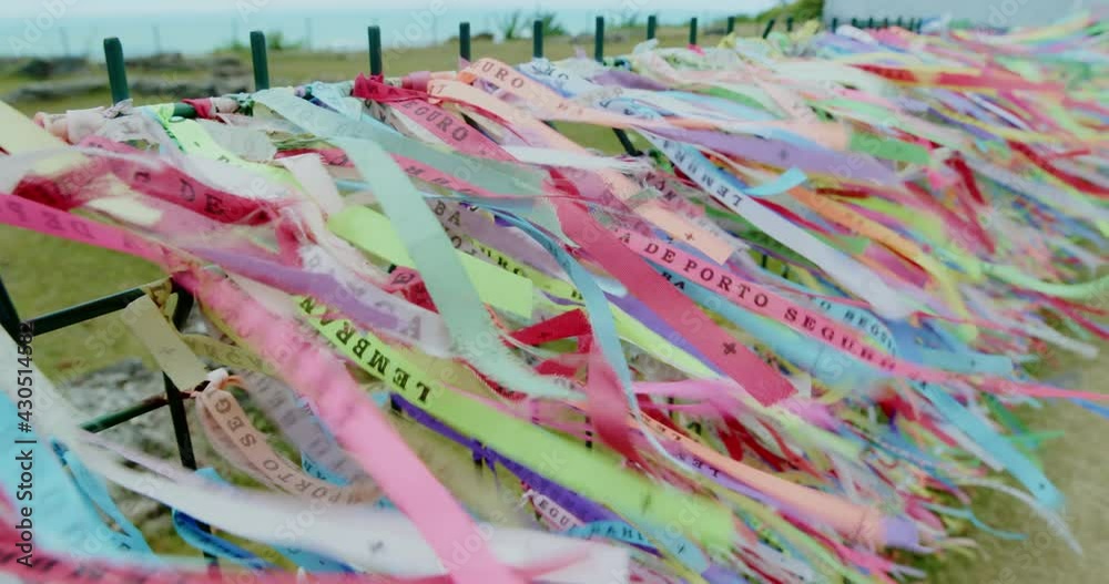 Closeup of colorful ribbons in Bahia, Brazil. Man hand making an ...