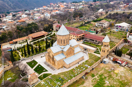 Scenic aerial view of old Georgian town of Mtskheta in valley of Caucasus mountains overlooking Samtavro Orthodox monastery complex in springtime photo