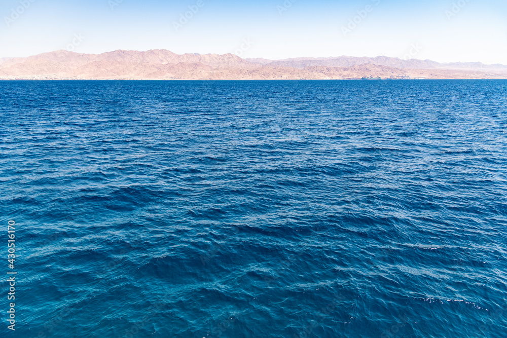 A view of the coral reef above the water. The Red Sea. Beach in the city of Eilat, Israel High angel, Mountains of Aqaba Jordan. High quality photo