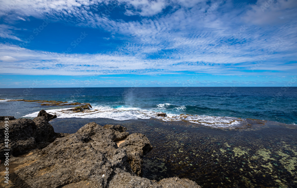 Coastal rock blowholes, a popular tourist site on the main island of Tonga, on a beautiful sunny day.