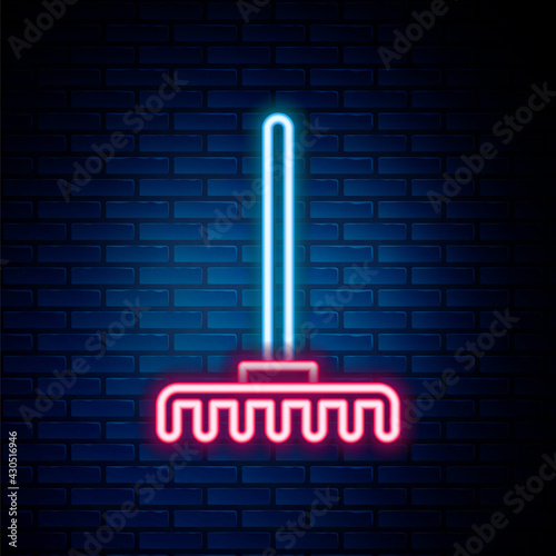 Glowing neon line Garden rake icon isolated on brick wall background. Tool for horticulture, agriculture, farming. Ground cultivator. Housekeeping equipment. Colorful outline concept. Vector