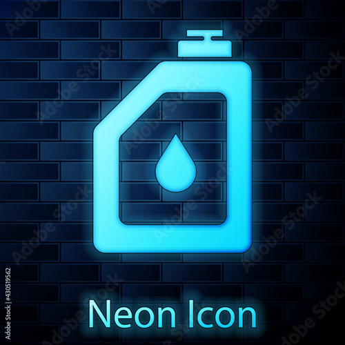 Glowing neon Canister for motor machine oil icon isolated on brick wall background. Oil gallon. Oil change service and repair. Engine oil sign. Vector