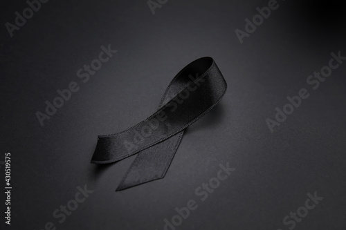 Black funeral ribbon on dark background