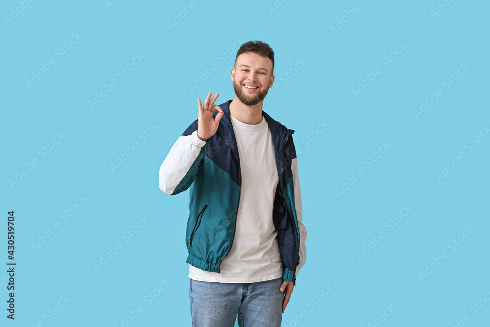 Handsome man showing OK on color background Handsome man showing OK on color background