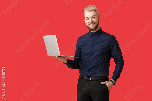 Young man with laptop on co...