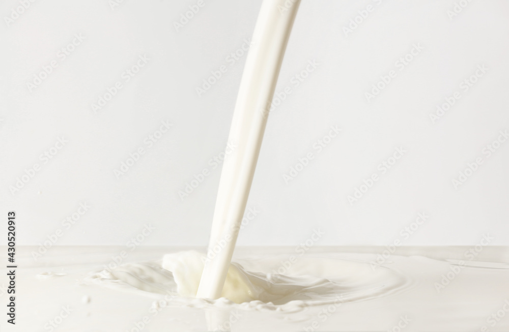Pouring of tasty milk on white background Pouring of tasty milk on white background