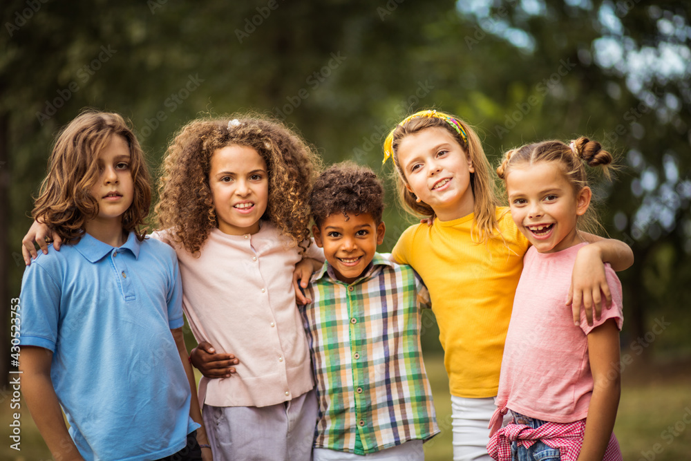 Portrait of smiling happy kids. Large group of school kids having fun in nature. Portrait of smiling happy kids. Large group of school kids having fun in nature.
