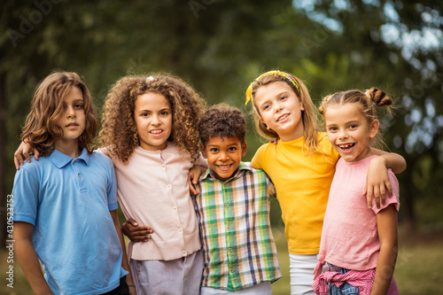 Portrait of smiling happy kids. Large group of school kids having fun in nature.