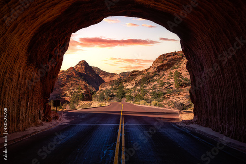Middle of the road from tunnel view of a scenic route in American Canyons Mountain Landscape. Sunset Sky Art Render. Taken in Zion National Park, Utah, United States.