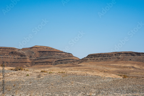 A view from the crater in the Ramon Crater. Arid desert view. White sands and a horizon of blue skies. Negev, Israel. High quality photo