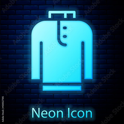 Glowing neon Shirt kurta icon isolated on brick wall background. Vector