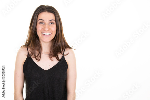 Young beautiful surprised good news woman portrait on isolated white background © OceanProd