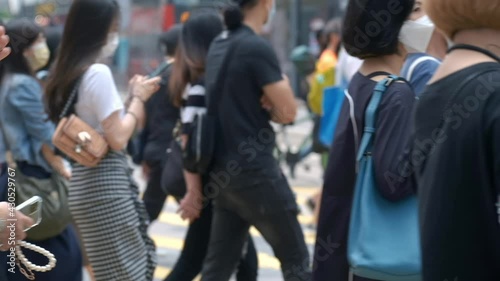 Slow motion of unrecognized people wearing medical face mask in Hong Kong. Coronavirus concept photo