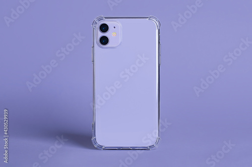 Purple iPhone 11 in clear silicone case back view isolated on purple background. Phone case mockup photo