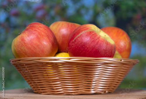 red apples in a wicker basket close up