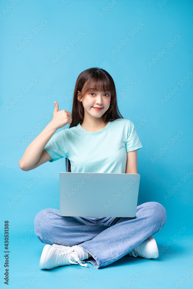Image of young Asian girl on blue background Image of young Asian girl on blue background
