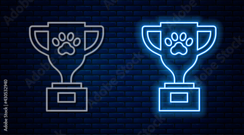 Glowing neon line Pet award symbol icon isolated on brick wall background. Medal with dog footprint as pets exhibition winner concept. Vector