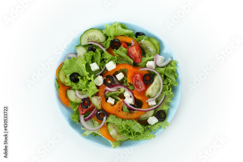 Plate of greek salad isolated on white background