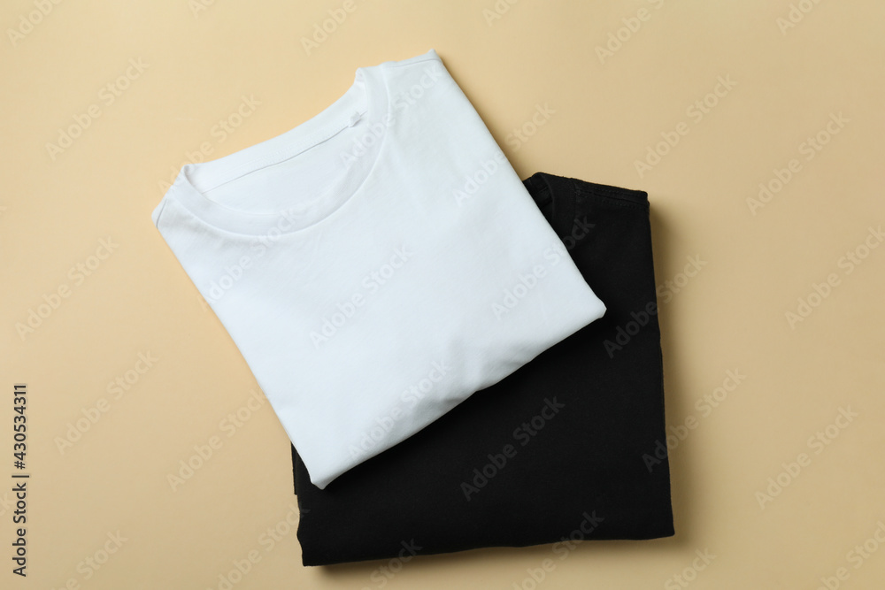 Black and white sweatshirts on beige background