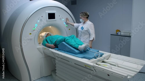 Doctor doing mri scan to patient woman