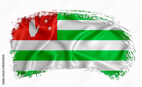 Abkhazia flag, brush stroke, typography, lettering, logo, label, banner on a white background. photo