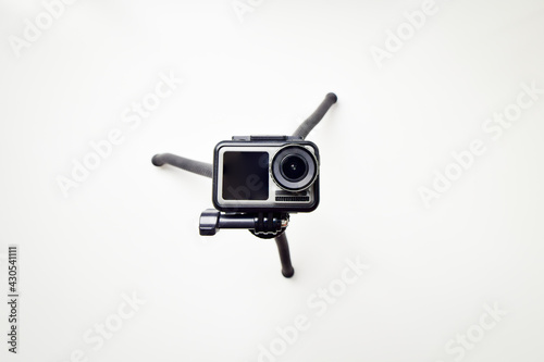 Action camera isolated on a white background with tripod looking up straight