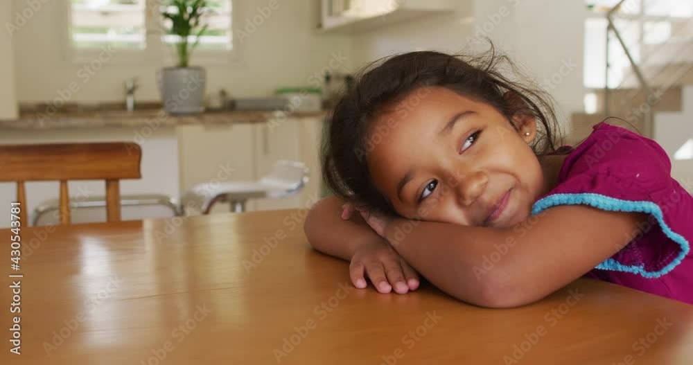 Portrait of happy hispanic girl relaxing lying on table Portrait of happy hispanic girl relaxing lying on table