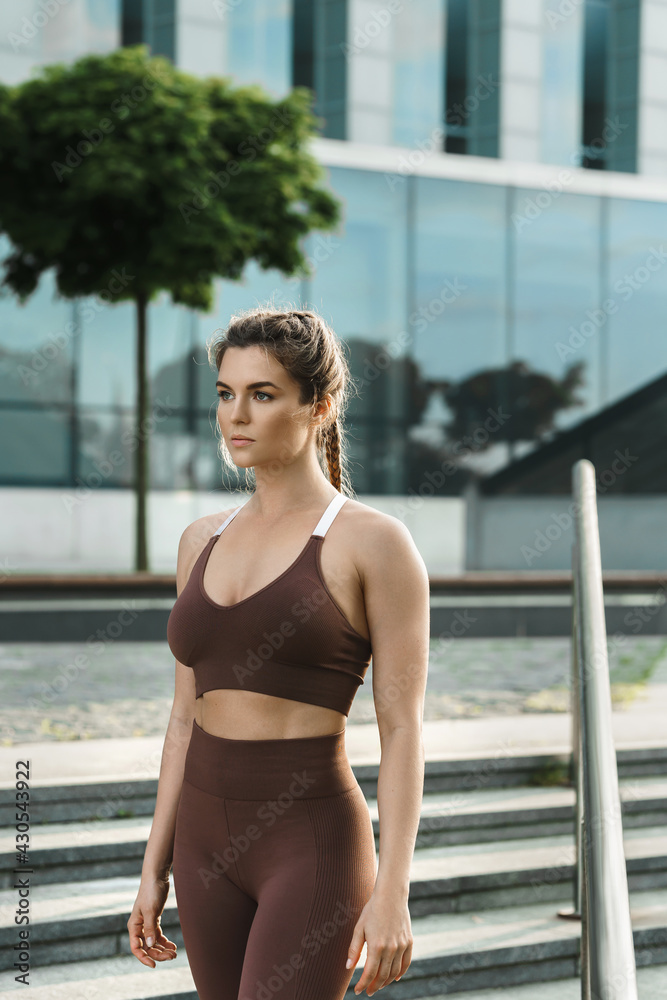 Portrait of sportive woman during her outdoor fitness workout