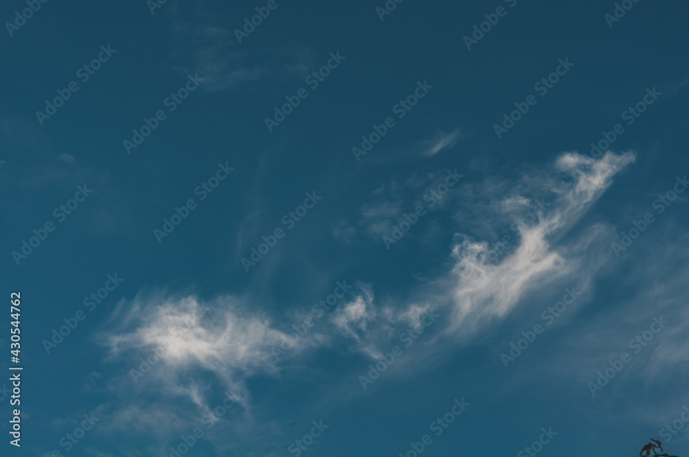 Dark blue sky with small cloud air, cloud evaporates under influence sun Dark blue sky with small cloud air, cloud evaporates under influence sun