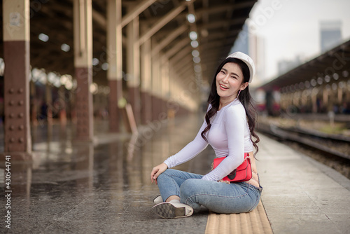 Asian female tourists are taking her to places of joy, emotional excitement, using public rail transport.