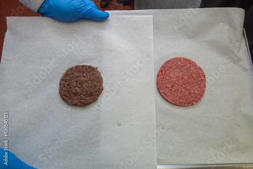 Raw and fried burger cutlet on parchment paper. Cooking a burger