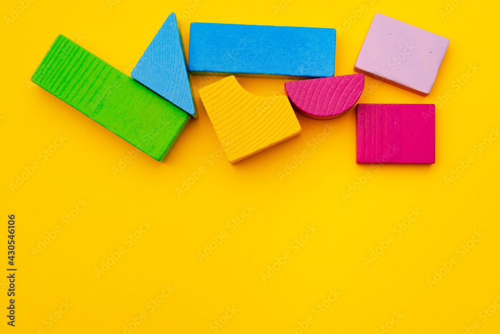 Toy kid's constructor on yellow background top view Toy kid's constructor on yellow background top view