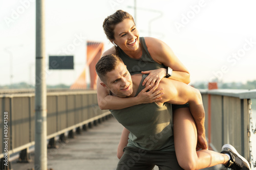 Fitness couple on a bridge after fitness workout during a sunset