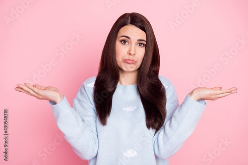 Photo of nice sad long hairdo brunette lady hold empty space wear blue sweater isolated on pastel pink color background