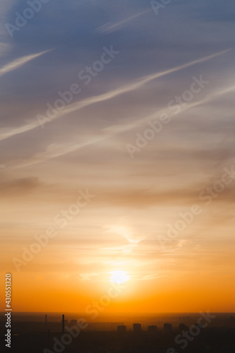 Beautiful bright summer sunset sky, yellow, orange and blue color natural background, vertical picture