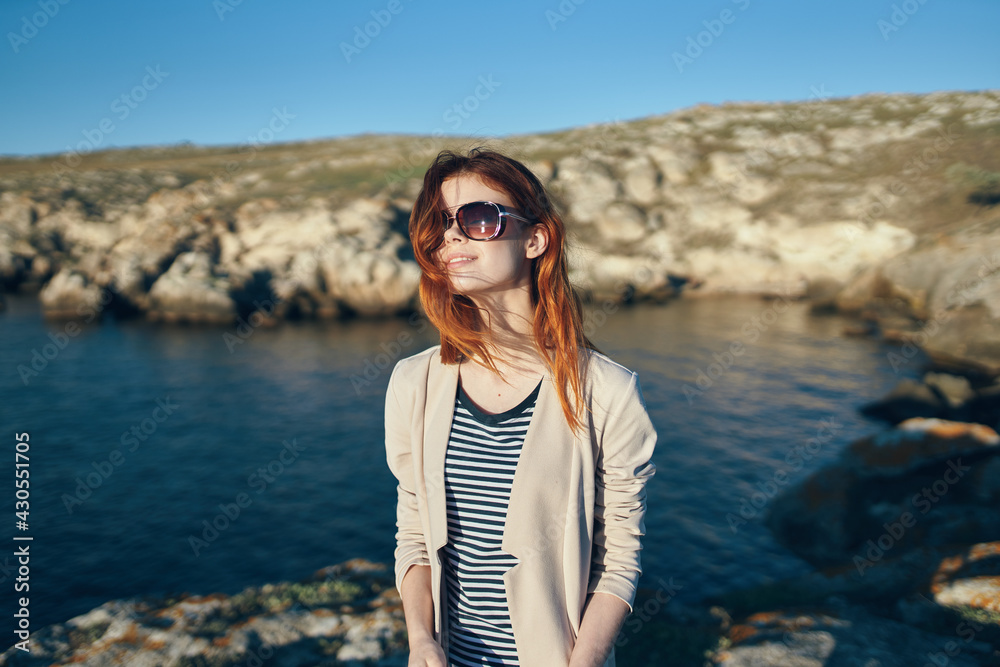 woman hiker in t-shirt glasses on nature in the mountains fresh air sea lifestyle woman hiker in t-shirt glasses on nature in the mountains fresh air sea lifestyle