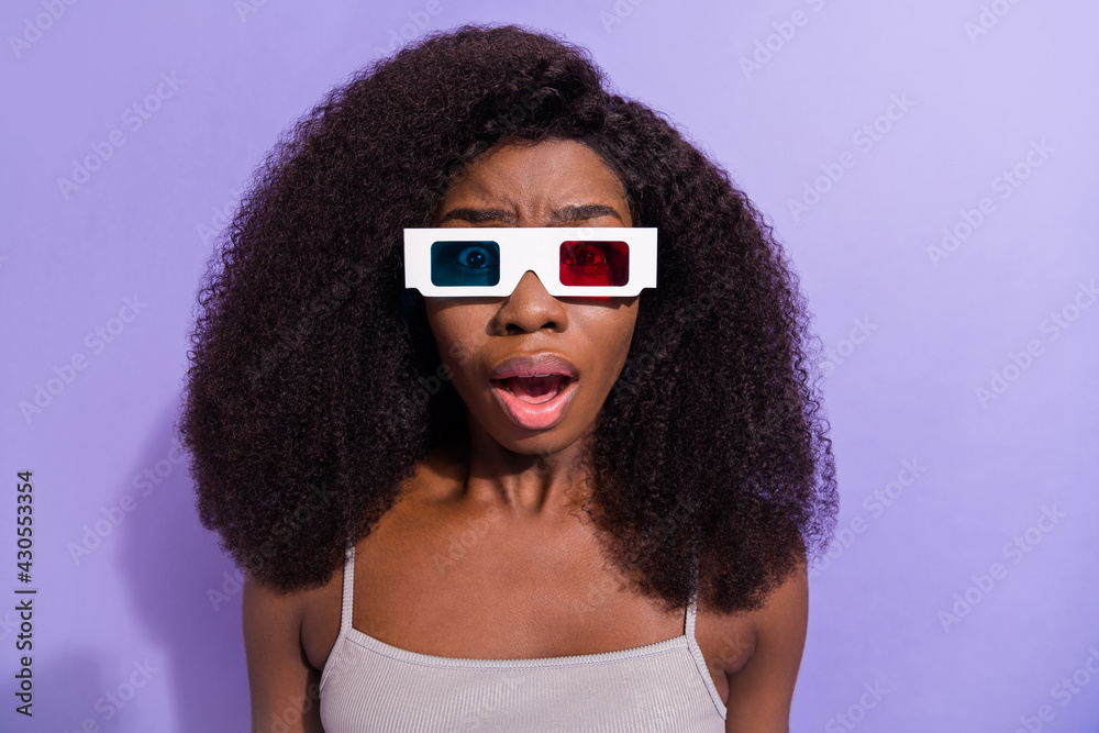 Close-up portrait of attractive amazed worried puzzled girl wearing 3d specs watching tv isolated over violet purple color background