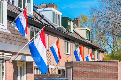 Obraz na płótnie Dutch Flags hanging outside houses in Alkmaar, Netherlands to celebrate King's Day on April 27, a national Holiday in The Netherlands w salonie