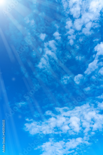 Photography Blue sky with beautiful clouds. Sun glare and rays of the sun