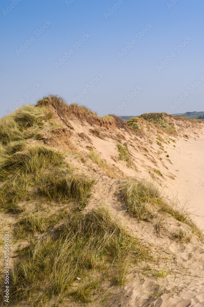 Sand dunes leading to the sea in a beach holiday setting Sand dunes leading to the sea in a beach holiday setting