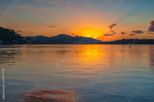Sunrise waterscape with scattered clouds