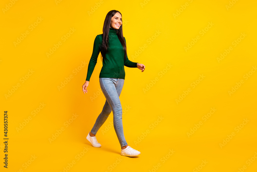 Full size profile side photo of young charming lovely positive girl go walk look copyspace isolated on yellow color background