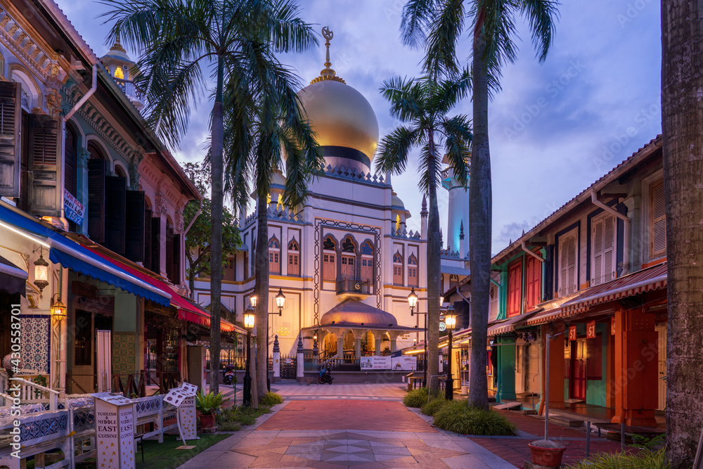 Fototapeta premium Illuminated Arab street and Masjid Sultan Mosque with no people during city lock down at Kampong Glam, Singapore.