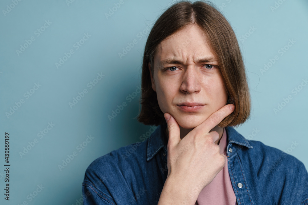 Young european man frowning and looking at camera Young european man frowning and looking at camera