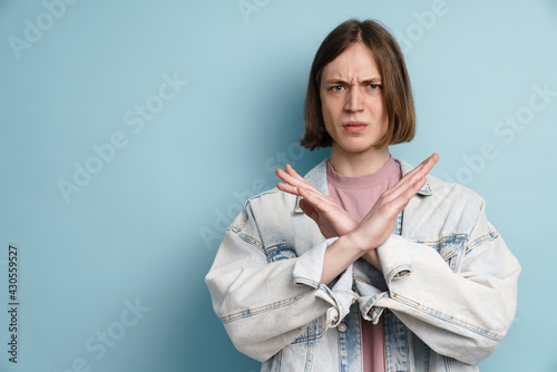 Young european man frowning and showing stop gesture