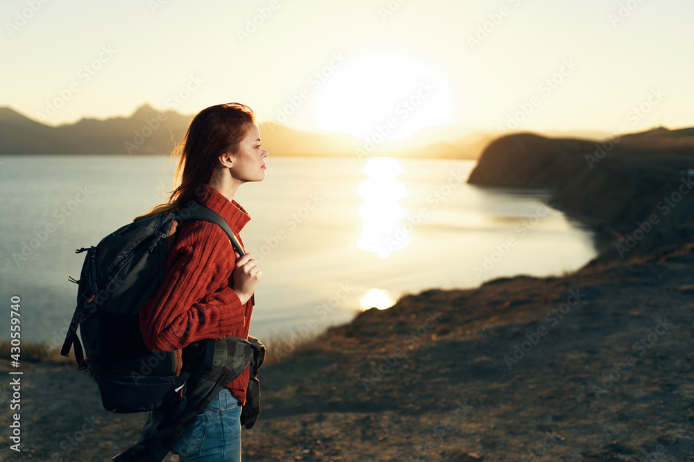 Fototapeta premium woman tourist with backpack landscape sunset travel